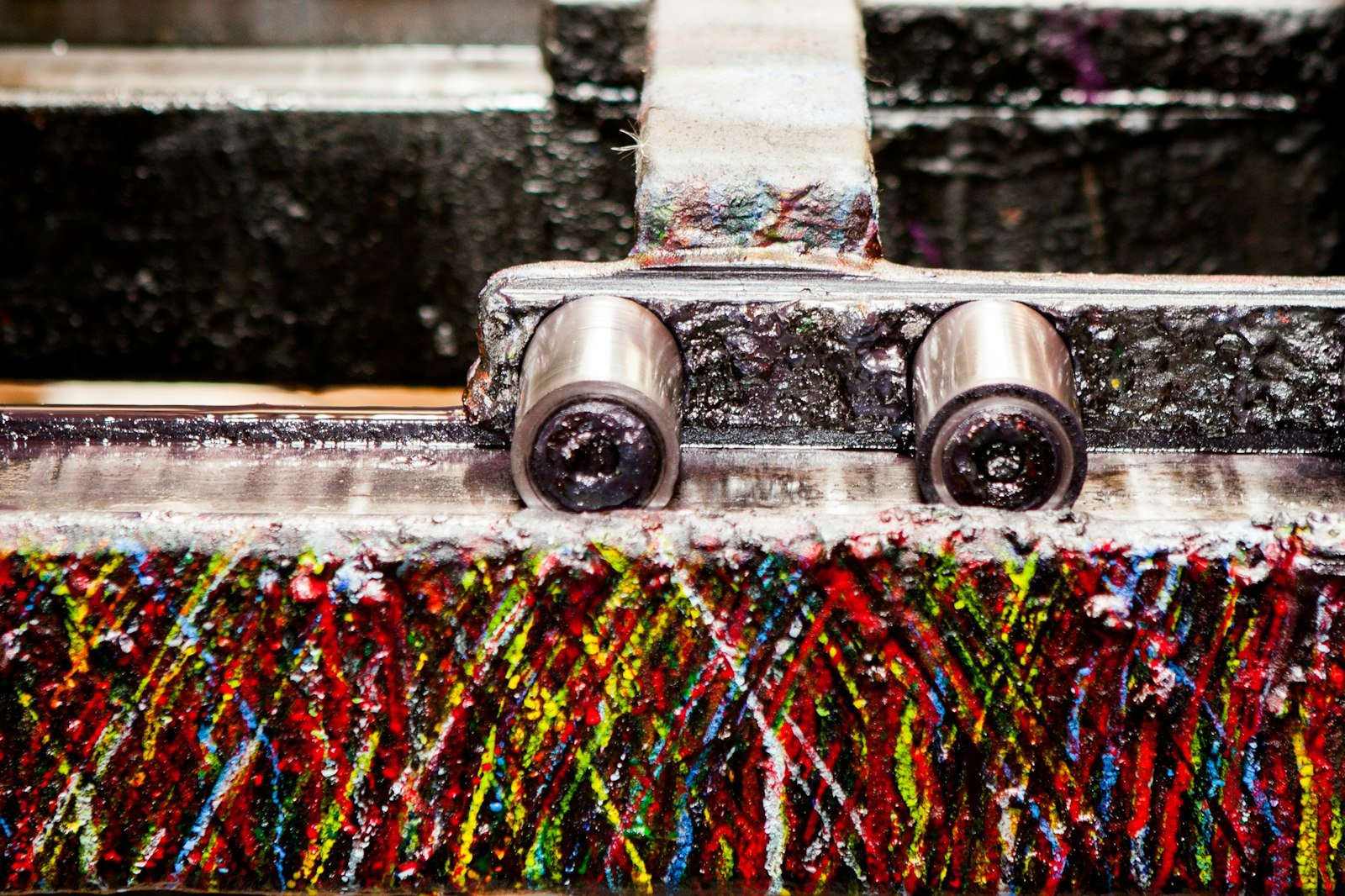 Close-up of a carpet cleaning machine brush with colorful bristles, showcasing the cleaning mechanism relevant to professional carpet cleaning services in Chippenham.