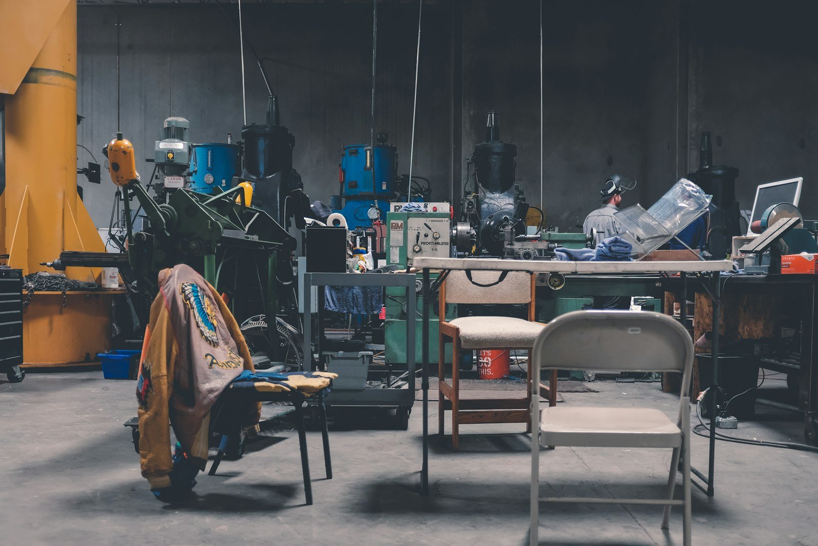 Commercial cleaning equipment and workspace with tools, chairs, and machinery in a busy industrial setting, reflecting Chippenham Cleaning's focus on practical standards and hygiene-sensitive environments.